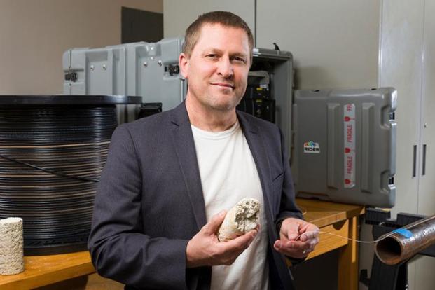 Dr. Scott Wasman holding core sample